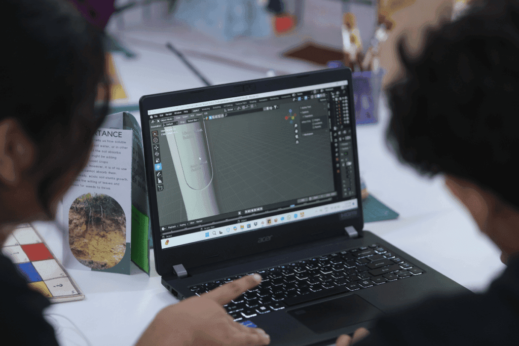 Student documenting project outcomes on a laptop screen